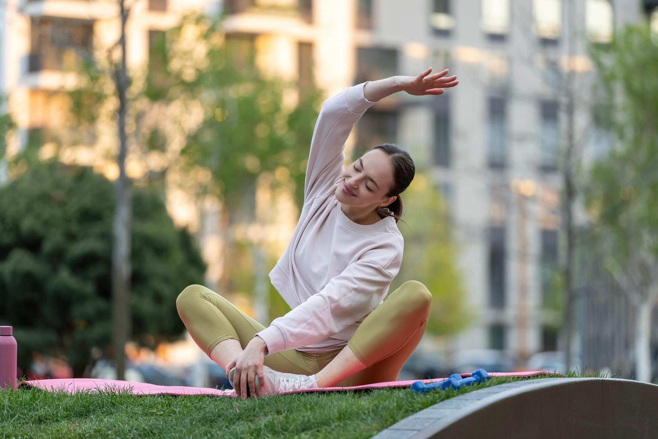 Woman stretching outdoors to represent balanced daily wellness